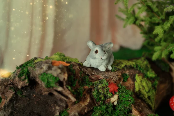 Decoration - bunny on driftwood with moss — Stock Photo, Image