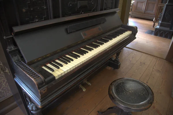 Old wooden piano in abandoned dark room