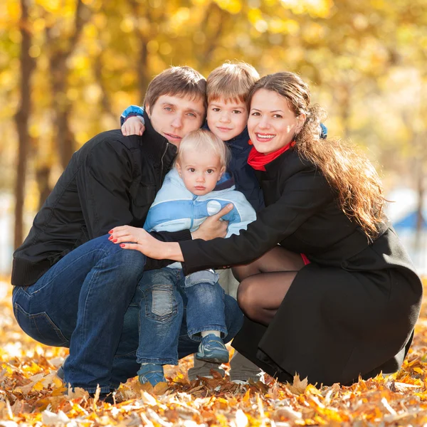 Happy family in the autumn park — Stock Photo, Image