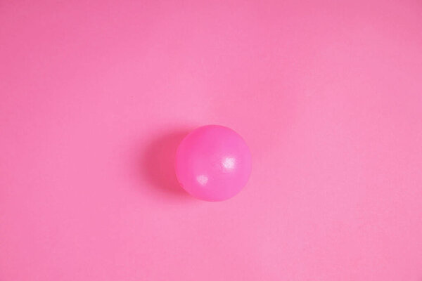 pink ball on pink scene.Simplicity taken from a bird's eye view.light and shadow in the studio