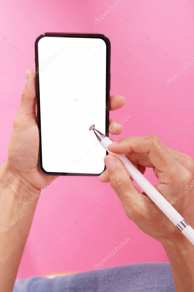 hand holding phone with a pen for a smartphone.on the pink scene isolate.empty space for text
