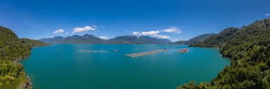 Aerial Panoramic salmon farms at Reloncavi marine strait at Llanquihue National Park, Chile, South America..