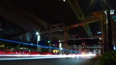 Tokyo 'da otoyolun altındaki caddenin gece şeridi. Geniş açılı çekim.