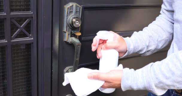 Disinfecting door knob by cleaner at the entrance — Stock Video