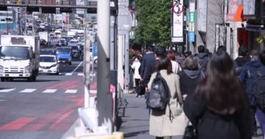 Shinjuku kentindeki yürüyen insanların vücut parçaları yüksek hızda.