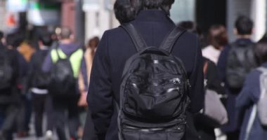 Shinjuku 'daki şehir merkezinde yüksek hızlı yürüyen ofis çalışanları.