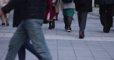 Shinjuku kentindeki yürüyen insanların vücut parçaları yüksek hızda.