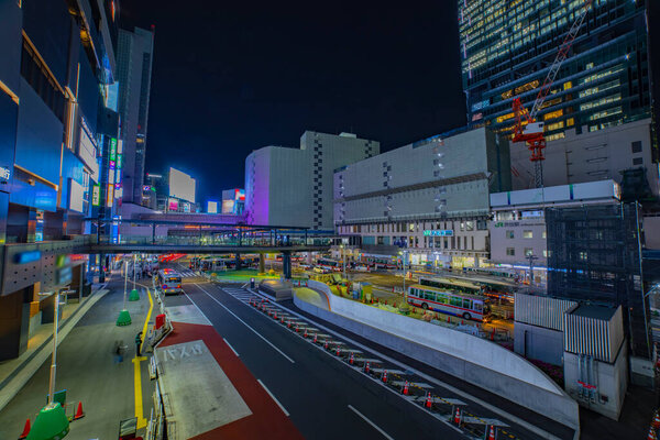 A night timelapse of the neon street near Shibuya station wide shot. Shibuya district Shibuya Tokyo Japan - 04.12.2021 : Here is center of the city in Tokyo.