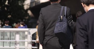 Shibuya 'daki şehir şehrinde yürüyen insanların yavaş çekimleri.