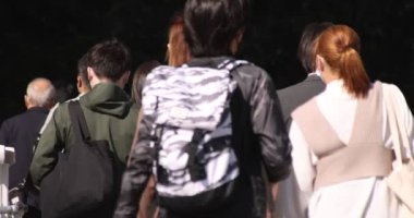 Shibuya 'daki şehir şehrinde yürüyen insanların yavaş çekimleri.