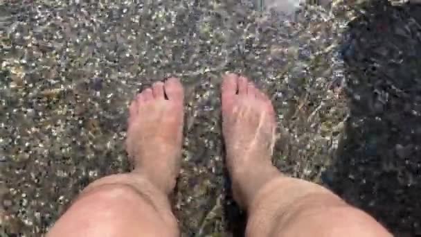 Pés de homens que entram no banho de pés na água quente handheld — Vídeo de Stock