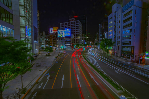 A night timelapse of the urban city street in Aoyama wide shot. Minato district Aoyama Tokyo Japan - 04.23.2021 It is center of the city in Tokyo.