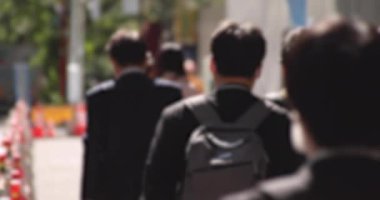 Tokyo 'daki kentsel kentte yürüyen insanların yavaş çekim gücü azaldı.