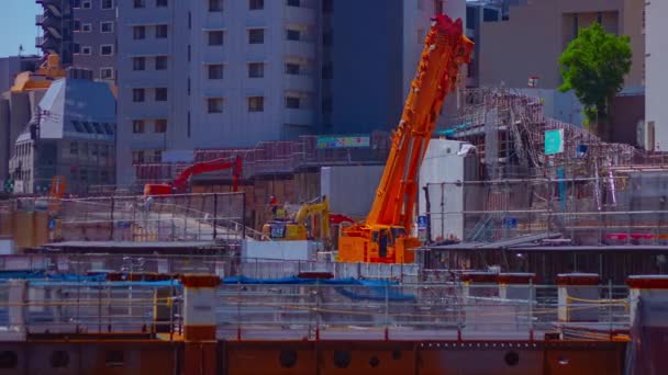 Um timelapse de guindastes em movimento na construção em Shibuya tiro longo panning — Vídeo de Stock