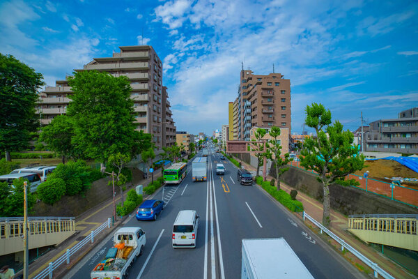 A timelapse of traffic jam at the avenue daytime wide shot. Nerima district Tokyo Japan 05.21.2021 It is a downtown street in Tokyo.
