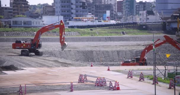 Moving cranes at the under construction daytime long shot — Stock Video