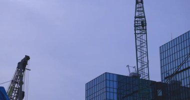 A cityscape of moving crane at the under construction in Tokyo. High quality 4k footage. Minato district Aoyama Tokyo Japan 10.08.2025 It is center of the city in Tokyo. 