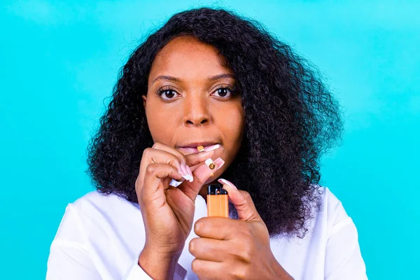afro woman winning with addicted nicotine problems, stop smoking studio blue background