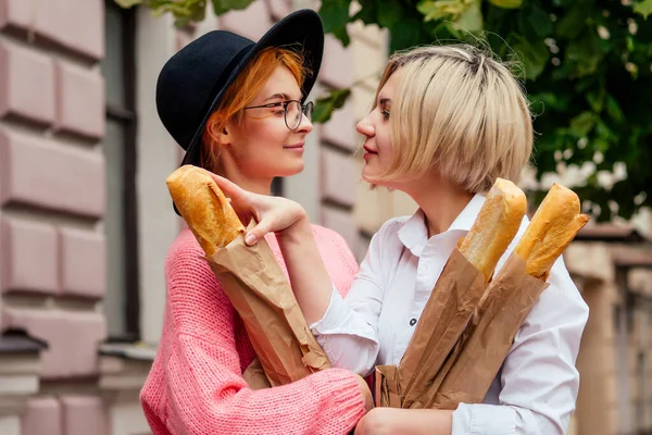 Pelirroja joven pelirroja sintiendo amor a su novia rubia en las calles de Europa — Foto de Stock