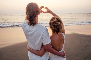 Kumsalda koşan evli bir çift.