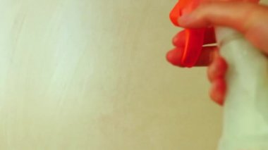 Yakın plan kadın yıkayıcı banyoda temizlik yapıyor. Sünger ve dezenfektan tutan bir el.