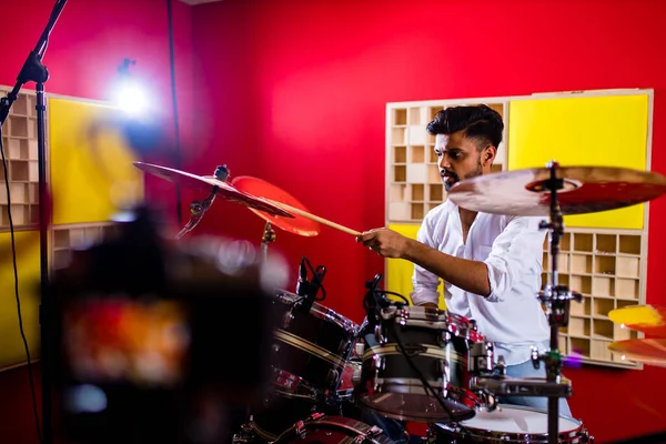 Young arabic man in a professional recording studio