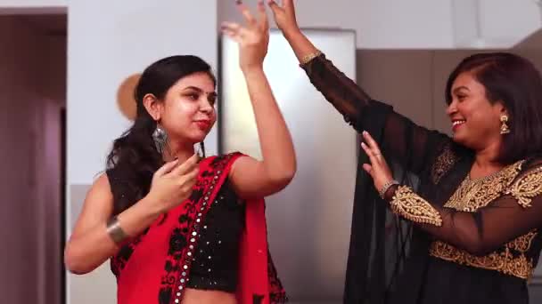 Two beautiful indian happy sisters dancing in living room in home — Stock Video