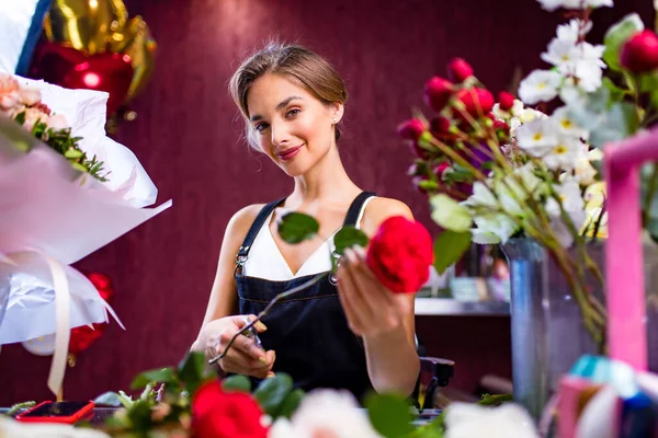 young woman flower store manager standing at workplace and smiling reopening shop sale