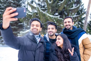 Arap erkekler Noel tatillerinde telefonda selfie çekerken harika vakit geçiriyorlar.