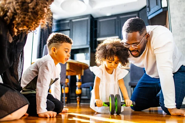 afro american mixed-raced family looking at camera in cozy summer day light in living room