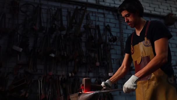 Slow motion video of italian brunette man blacksmith working in the workshop — Stock Video