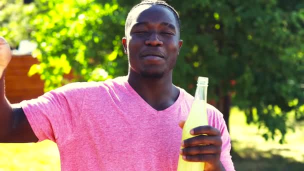 Latin brazilian man drinking fresh cold lemonade in hot summer day in sunny park and talking by video call with friend — Stock Video