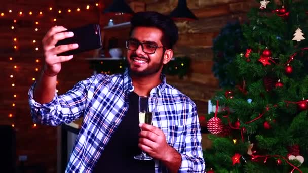 Indian man med videosamtal till familjen rostat bröd med ett glas champagne — Stockvideo