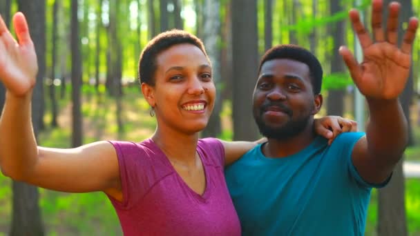 Latin american couple ready to yoga time outdoors pink and blue look taking self portrait on modern smartphone hi — Stock Video