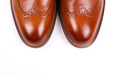 Cropped shot of a pair of light brown double monk strap shoes isolated on white background. Versatile business casual dress shoes without laces. Top view, copy space for text, flat lay. clipart