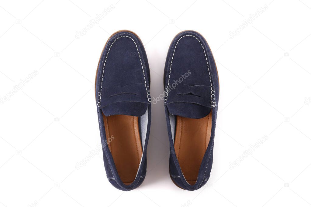 Cropped shot of a pair of dark blue penny loafers. Men's shoes isolated on white background. Suede moccasin without laces. Top view, copy space for text, flat lay.