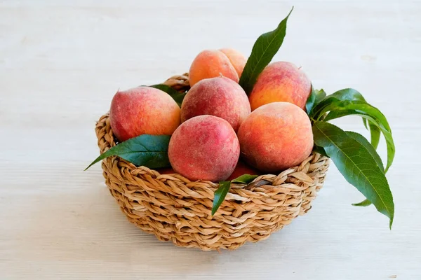 Bunch Ripe Organic Peaches Wicker Bowl White Wooden Table Background — Stock Photo, Image
