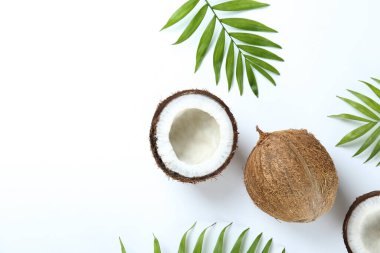 Hindistan cevizlerinin üst görüntüsü, kağıt üzerinde yarıya bölünmüş ve yarıya bölünmüş arka planda metin için bir sürü fotokopi alanı var. Tropik palmiye ağacının çiğ meyveli arka planı. Düz yatıyordu.