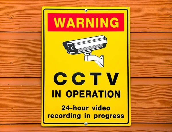 Sinal de vigilância. Câmera CCTV no fundo de madeira — Fotografia de Stock