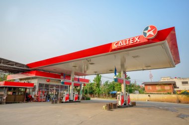 Sukhothai,THAILAND - March 30: Caltex Oil station on March 30,2013 in Sukhothai province, Thailand. Ready to service 24 hour. clipart
