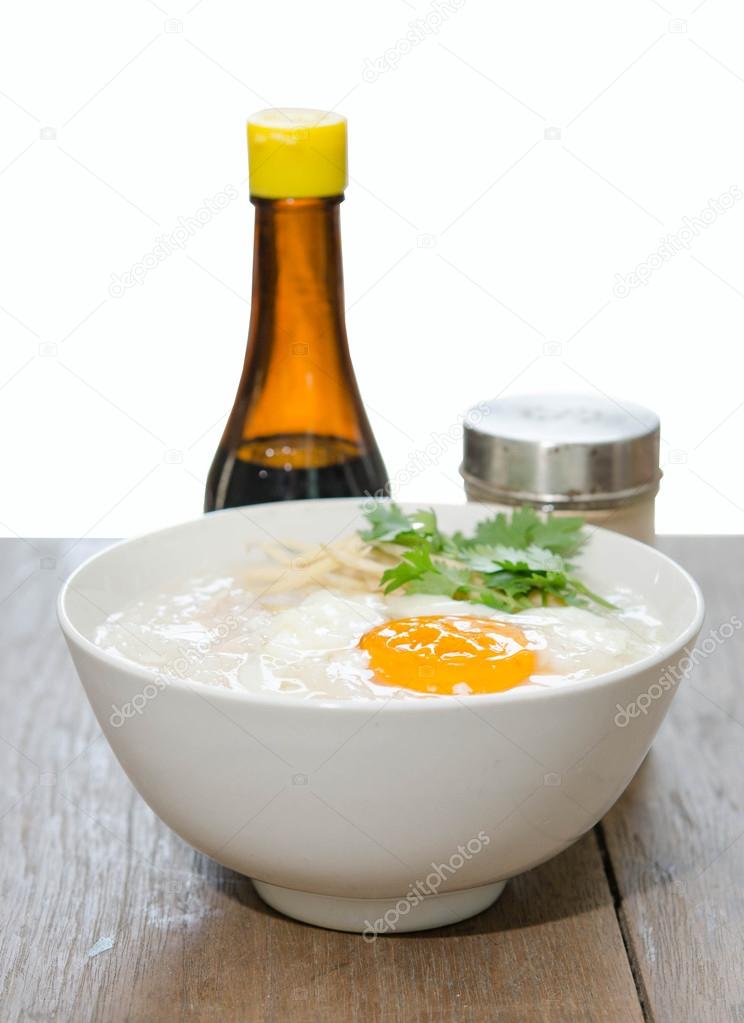 Congee of traditional food Chinese style with soft-boiled egg is