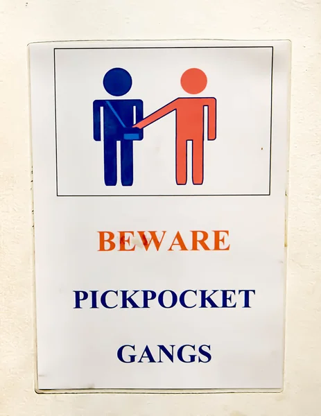 Sign beware of pickpockets on wall — Stock Photo, Image