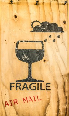 Glass icon of fragile item spray on brown plywood tex  clipart