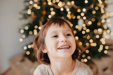 Mutlu genç kızın portresi, arka planda Noel ağacı..