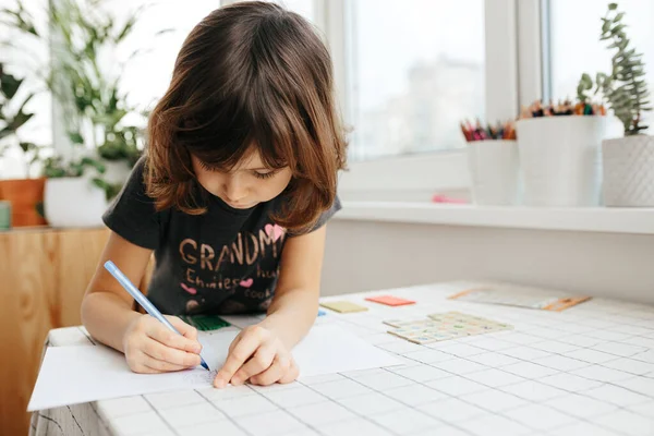 Cute five years girl learning maths at home. Education and distance learning for kids. Homeschooling concept. Coronavirus Outbreak. Lockdown and school closures.