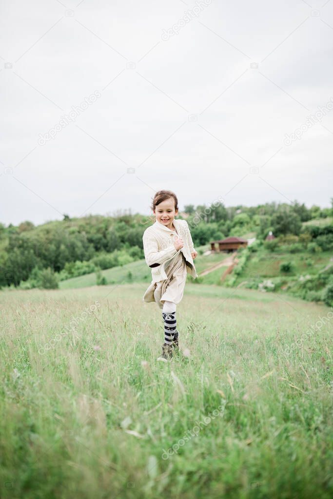 Young girl on the green hills on the farm