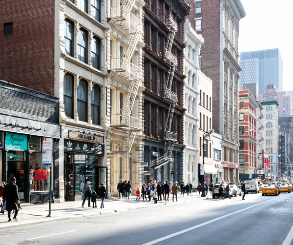 NEW YORK CITY CIRCA 2019: The street is crowded with people shopping at the stores along Broadway in the SoHo neighborhood of Manhattan in New York City.