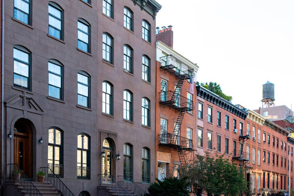 Block of old historic brownstone buildings in the Chelsea neighborhood of Manhattan in New York City NYC