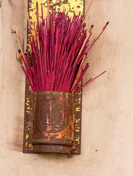 Red incense, on the wall.