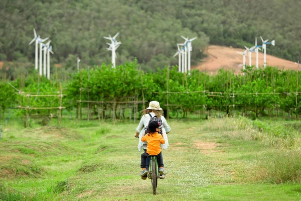 Woman Boy Riding Bicycle Farm Wind Turbines Background — Stock Photo, Image